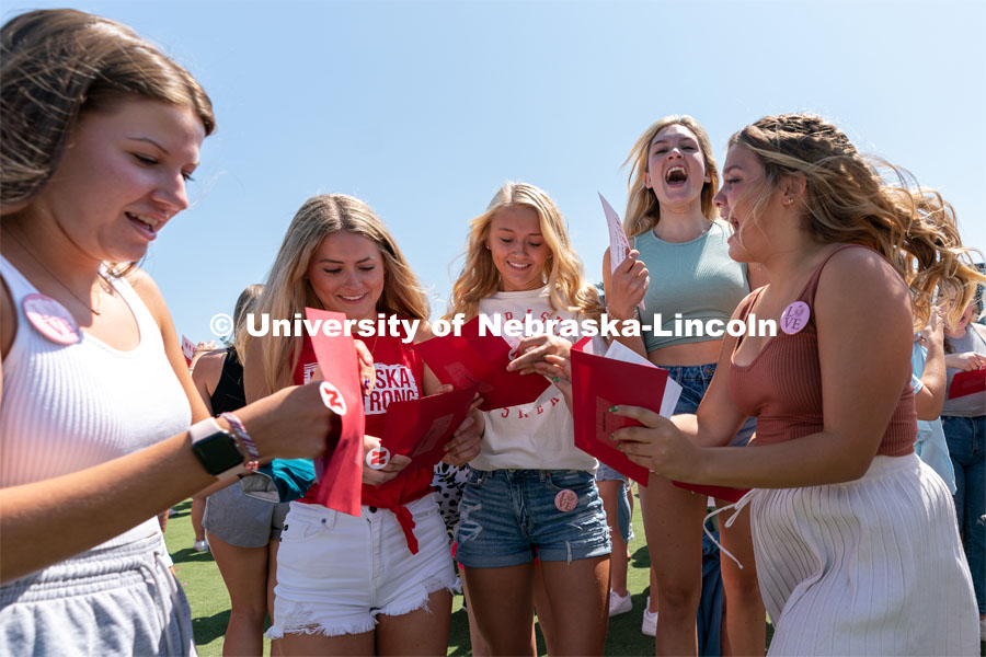 Students open their envelopes revealing which sorority chapter they will join during Sorority Rush Bid on the Vine Street fields. Sorority bid day recruitment. August 21, 2021. Photo by Jordan Opp / University Communication.